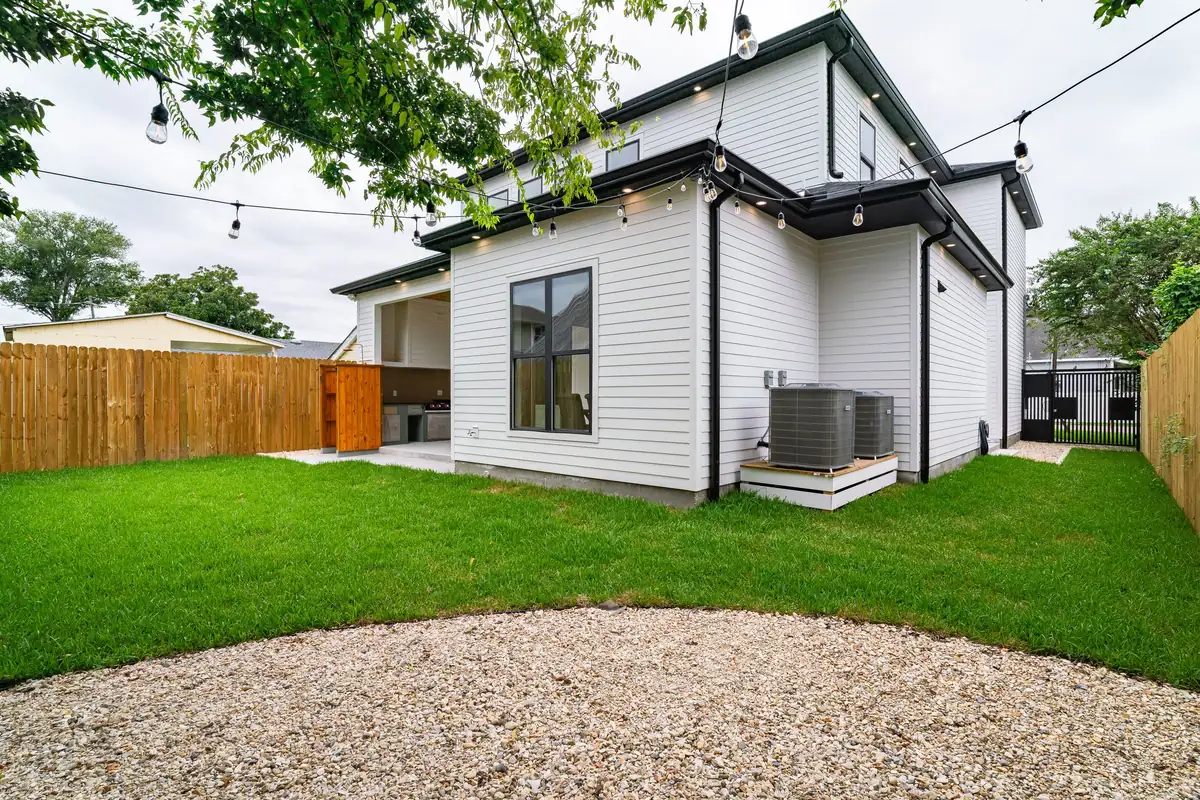 Wood privacy fence around a backyard lawn
